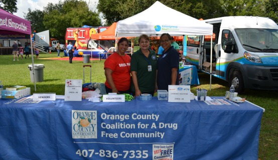 OC employees working a booth for Health Summit