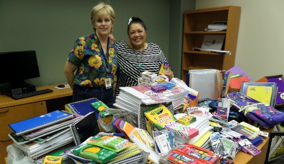Two women with school supplies
