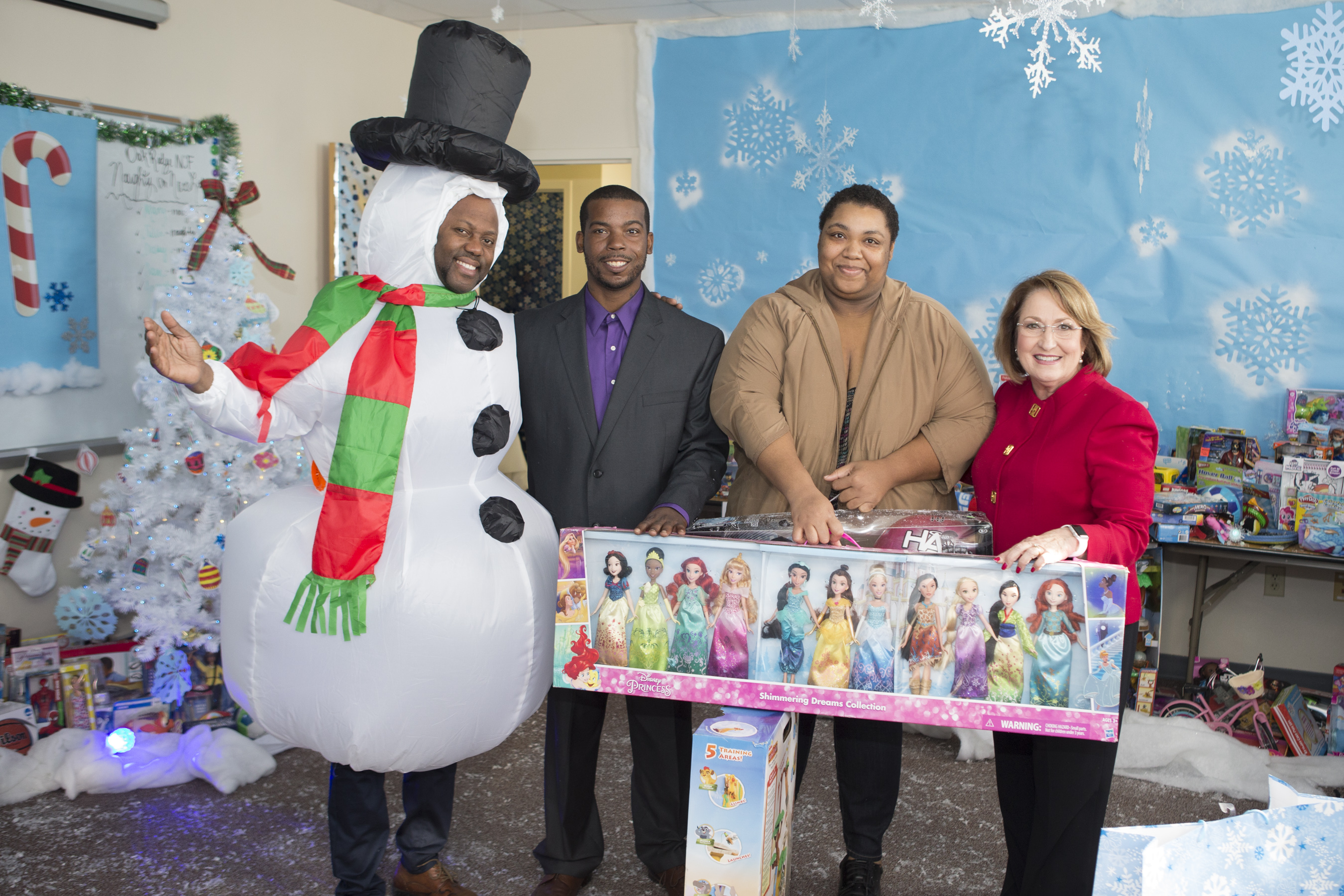 Mayor Teresa Jacobs and Toy Drive participants holding donated toys