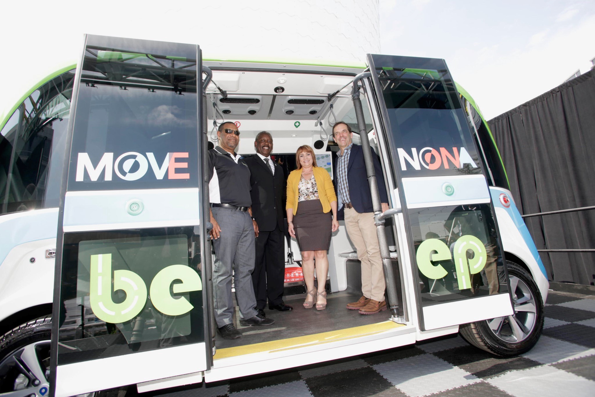 Mayor Demings, Commissioner Gomez Cordero, and two leaders are standing inside an autonomous bus made by Beep.
