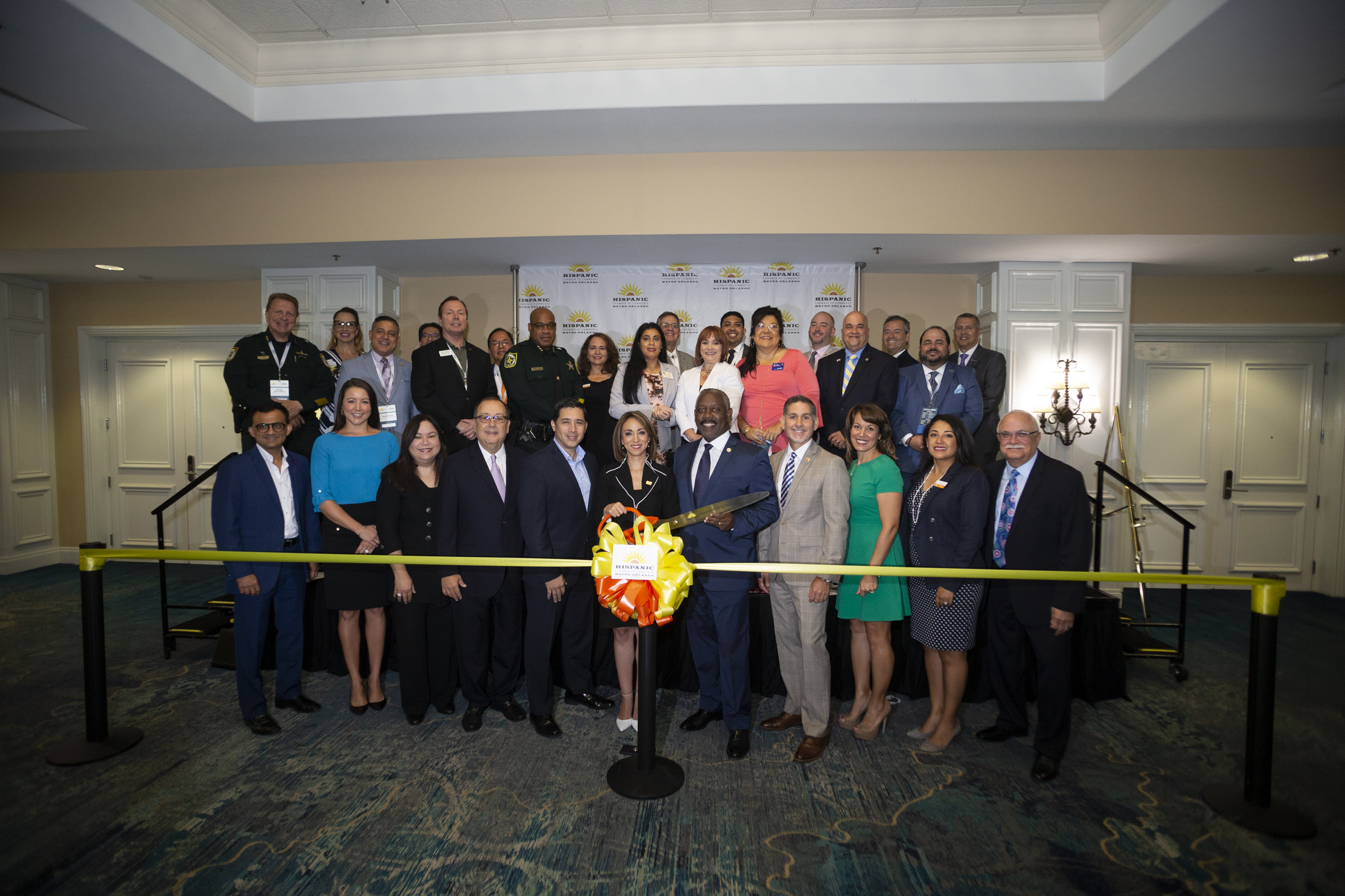 Community and business leaders gather to cut the ribbon at the Hispanic Business Conference.