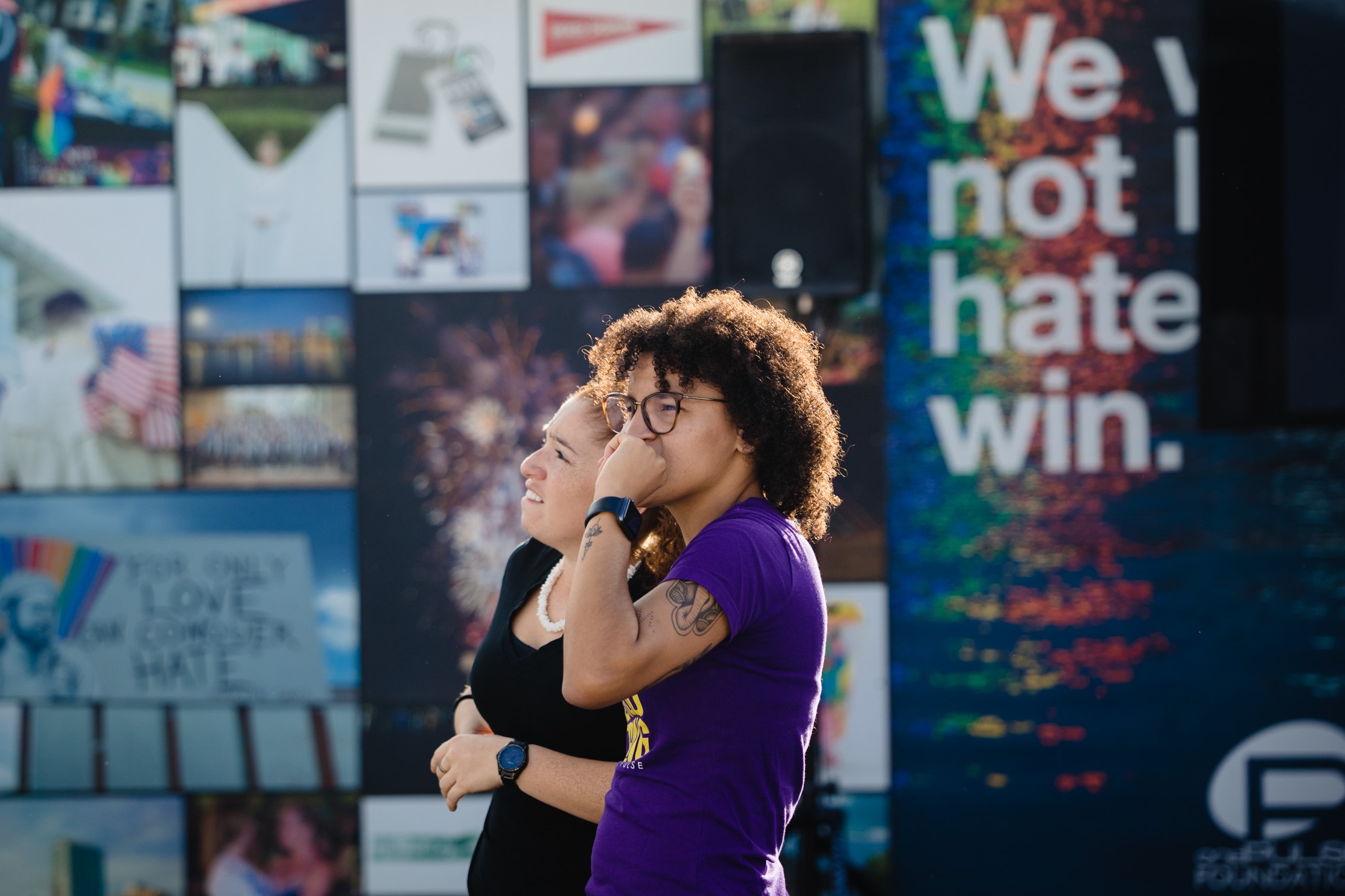 Two people stand in front of the Pulse memorial as they contemplate the artwork on display