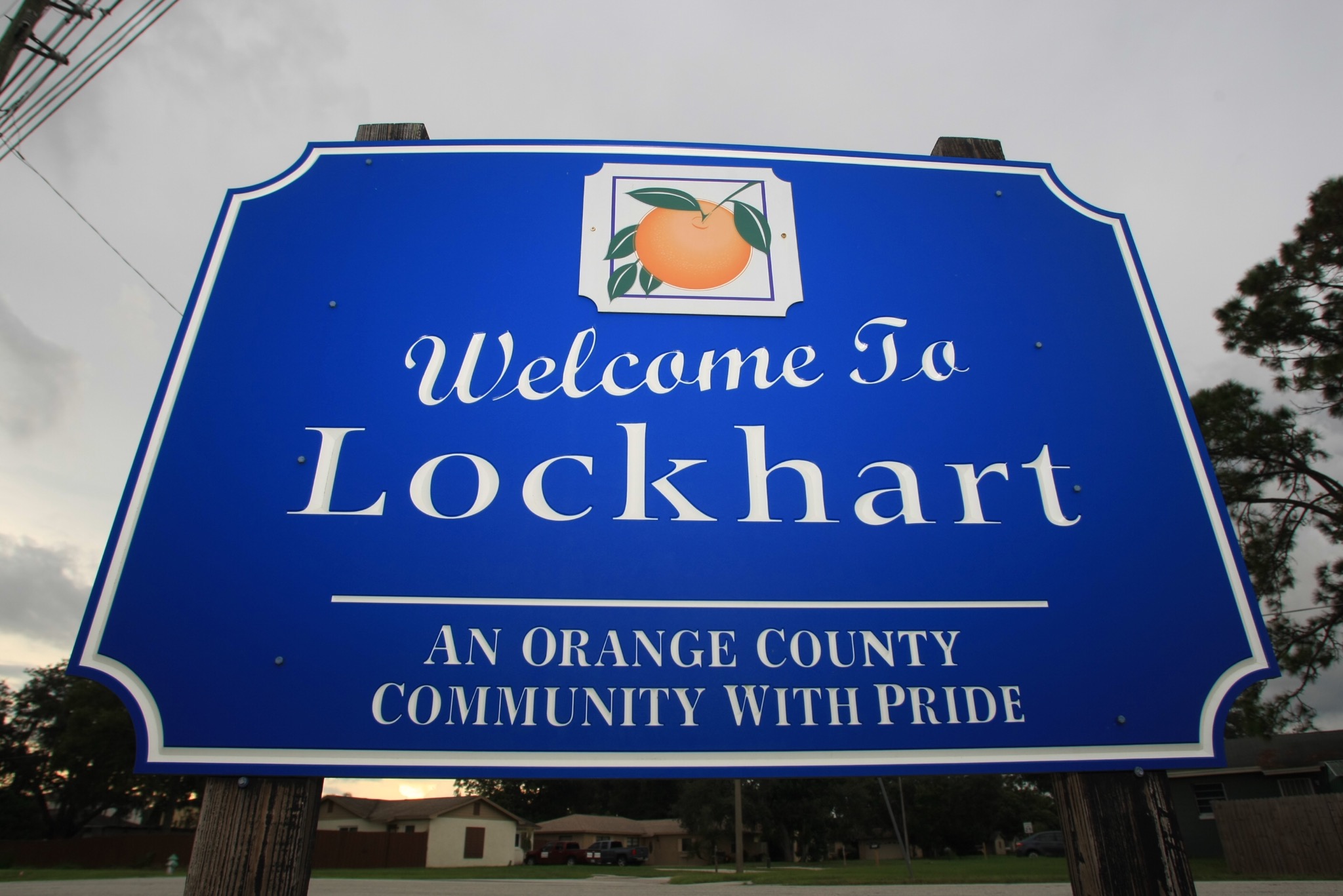 Sign reads: "Welcome to Lockhart, an Orange County Community with Pride"