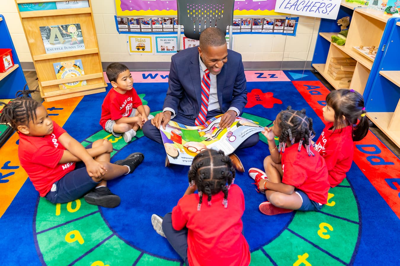 Orange County District 6 Commissioner Michael Scott reads to Head Start students at Lila Mitchell Center during Guest Readers Month to support early childhood literacy.