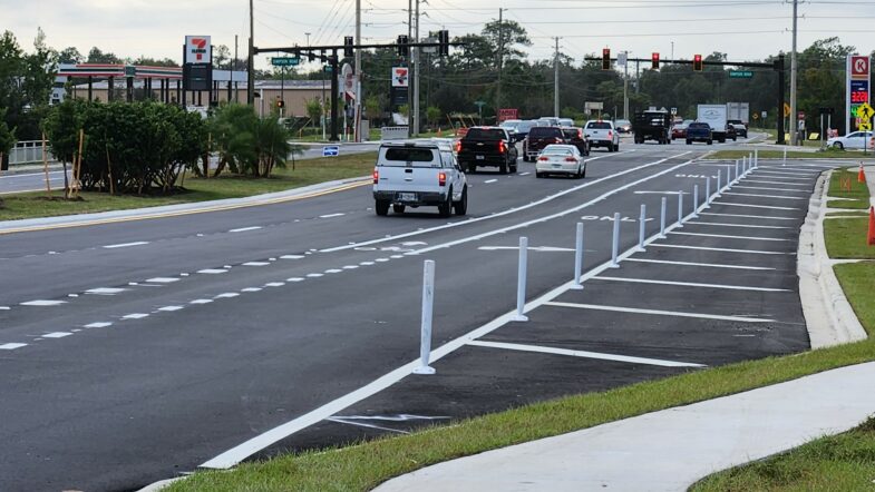Vehicles drive down the newly opened expansion on Boggy Creek Road in Lake Nona.